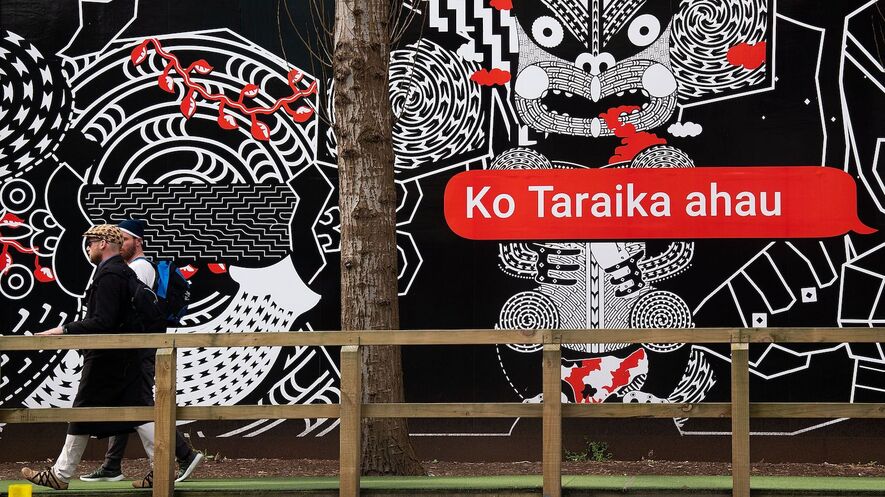 Image 1. People walk past Maori language signs in Wellington, New Zealand, on September 13, 2018. Photo by: Marty Melville/AFP/Getty Images