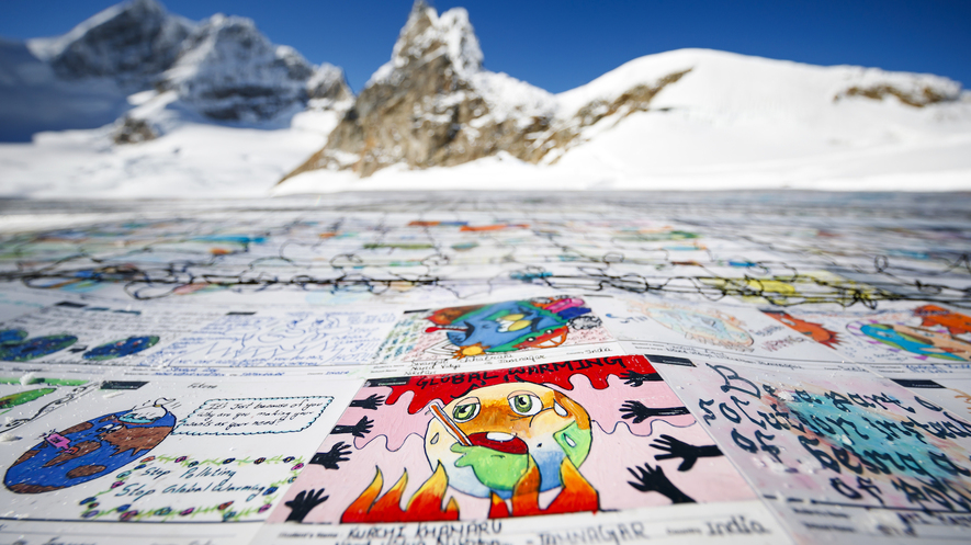 Image 1. A postcard of approximately 2,500 square meters, made of contributions from more than 125,000 individual postcards containing messages aiming to combat climate change, is pictured on the Aletsch Glacier in Switzerland, November 16, 2018. Photo by: Valentin Flauraud/Keystone via AP