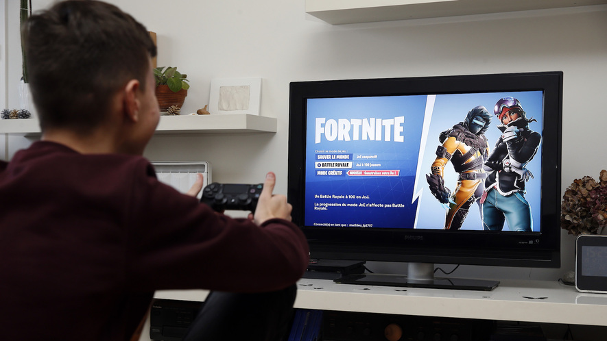 a gamer plays fortnite which was developed by epic games on a sony playstation game console ps4 pro in paris france december 19 2018 - playing fortnite on ps4 pro