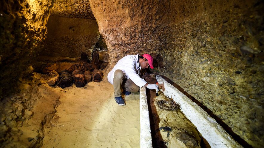 Image 1. An archaeologist brushes a newly discovered mummy laid inside a sarcophagus, part of a collection found in burial chambers dating to the Ptolemaic era (323 to 30 B.C.) at the necropolis of Tuna el-Gebel in Egypt's southern Minya province, about 150 miles south of the capital Cairo, in February 2019. Photo: Mohamed El-Shahed/AFP/Getty Images