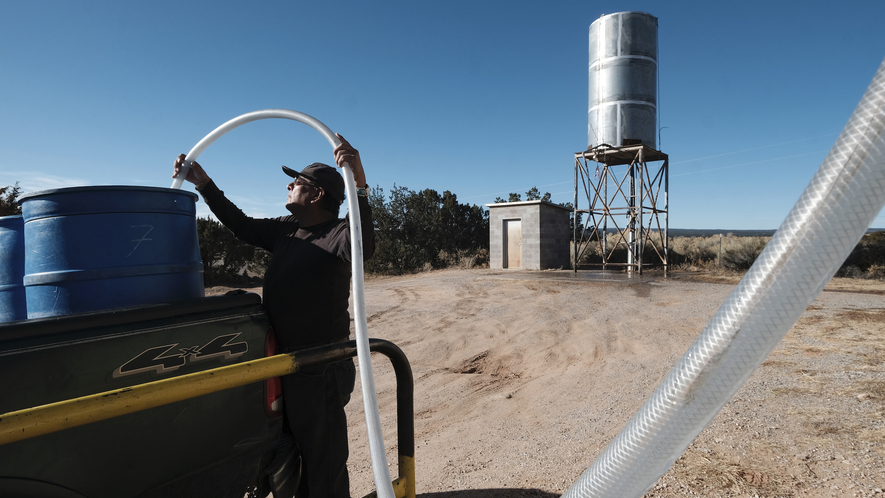 a man fills a bucket with a hose